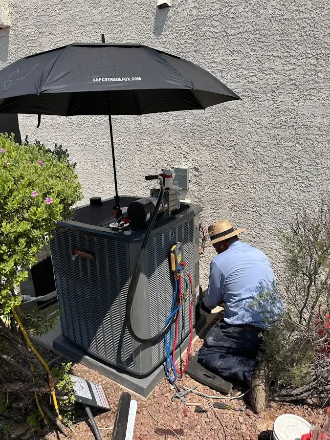 HVAC technician performing outdoor AC maintenance in Robstown